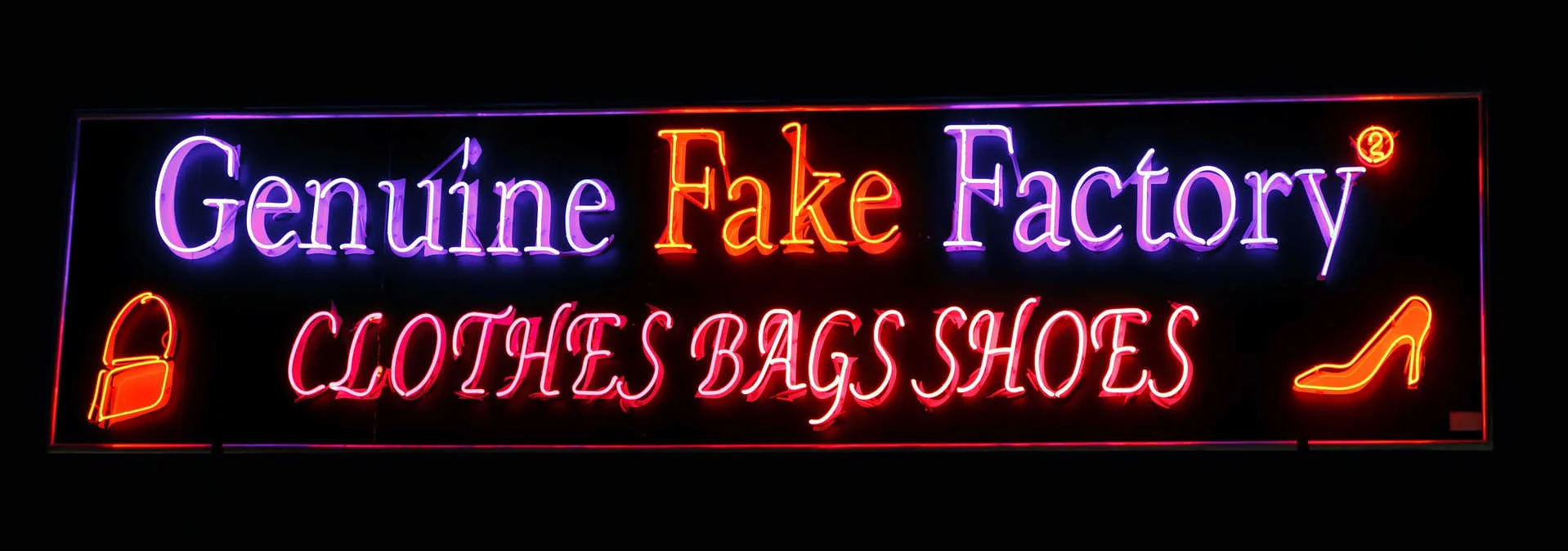 A neon sign advertising fake items, representing the influence of using fake items on unethical behavior.